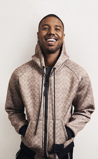 Michael B. Jordan for Coach Michael B. Jordan wearing a beige sweater